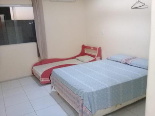 מיטה או מיטות בחדר ב-Casa Praia Luís Correia