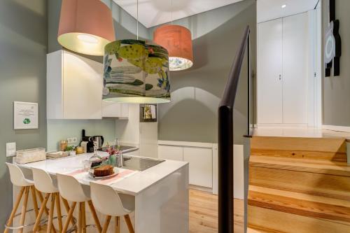 une cuisine avec un comptoir et des placards blancs dans l'établissement Janika's Apartment, à Porto