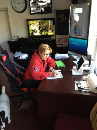 a woman sitting at a desk with a computer at Timen House in North Hollywood