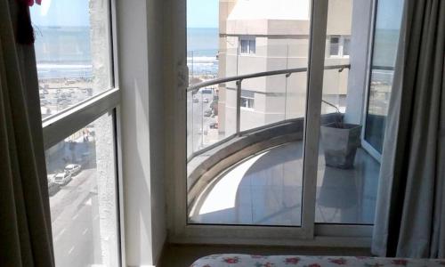 a room with a window with a view of a building at Mar del Plata in Mar del Plata