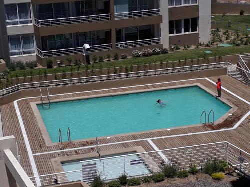 una persona nadando en una piscina en un edificio en Horizonte Infinito Viña del Mar, en Viña del Mar