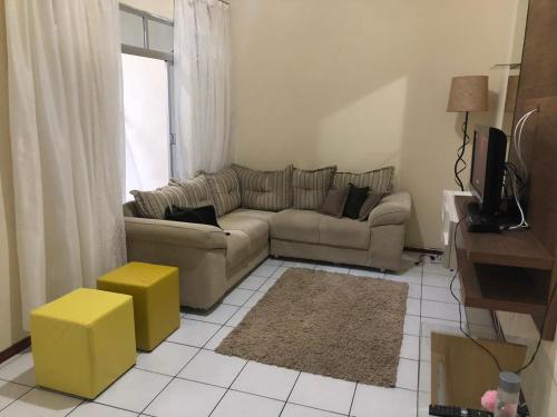 a living room with a couch and a window at Casa para temporada in Governador Celso Ramos