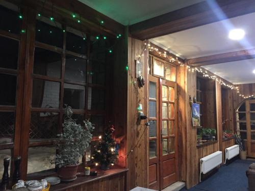 a room decorated for christmas with christmas lights at Pensiunea Nick in Sinaia