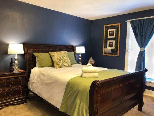 a bedroom with a large bed with blue walls at The Salida Inn and Hostel in Salida