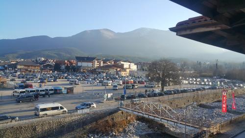 a parking lot with a bunch of cars parked at Koko's apartments in Bansko
