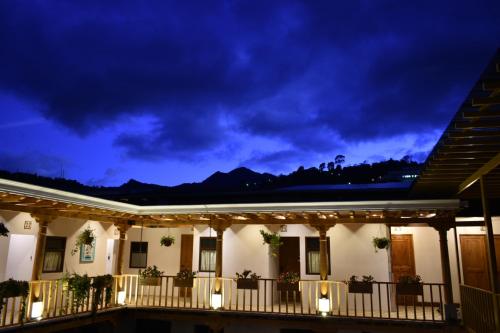 a house with a balcony at night at Casa Morasan Hotel-Boutique in Quetzaltenango