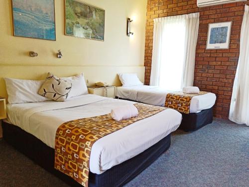 Ένα ή περισσότερα κρεβάτια σε δωμάτιο στο Glen Inn
