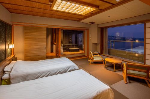 Säng eller sängar i ett rum på Musashi