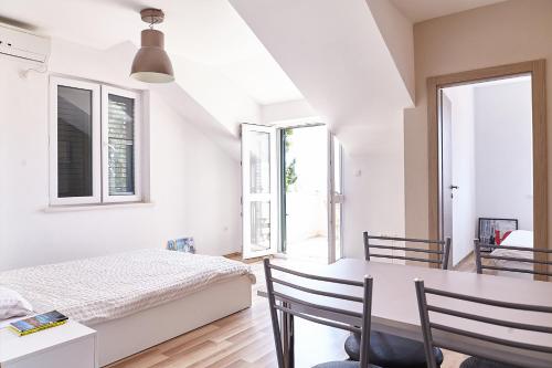 a bedroom with a bed and a table and chairs at Love Dubrovnik Hostel in Dubrovnik