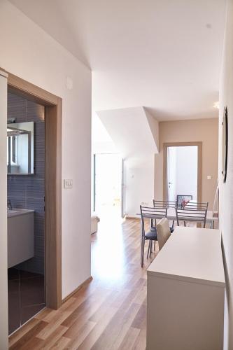a kitchen and living room with a table and a dining room at Love Dubrovnik Hostel in Dubrovnik
