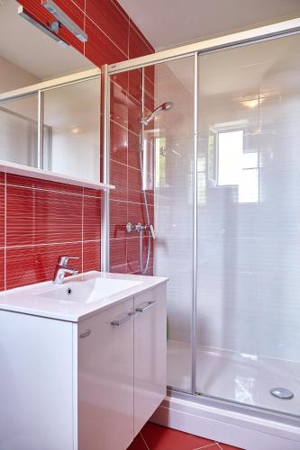 a bathroom with a white sink and a shower at Love Dubrovnik Hostel in Dubrovnik
