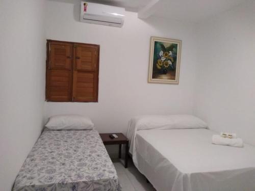Giường trong phòng chung tại Pousada Praia Bela Maceió