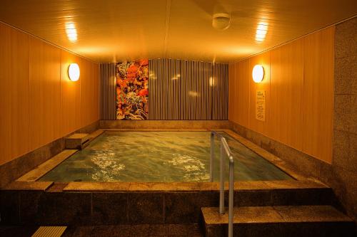 a jacuzzi tub in a room with lights at Hotel Hokke Club Fukuoka in Fukuoka