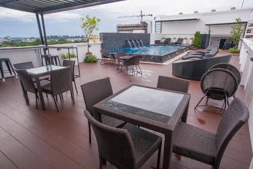 a patio area with chairs, tables and chairs at The Seens Hotel in Krabi town
