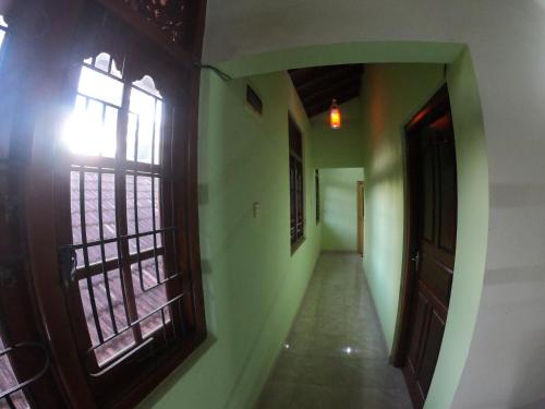 an empty hallway with an open door and a window at Villa Girilena in Hikkaduwa