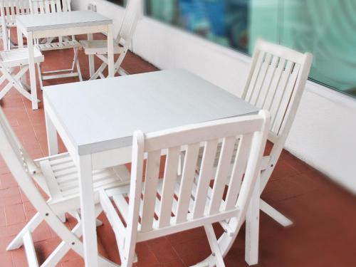 a white table with chairs and a white table cloth at Tune Hotel - Waterfront Kuching in Kuching