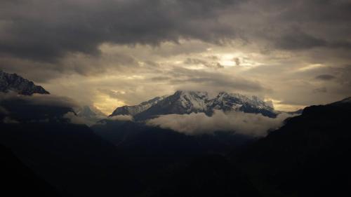 a snow covered mountain under a cloudy sky at Landhaus Seiringer Apartments in Finkenberg