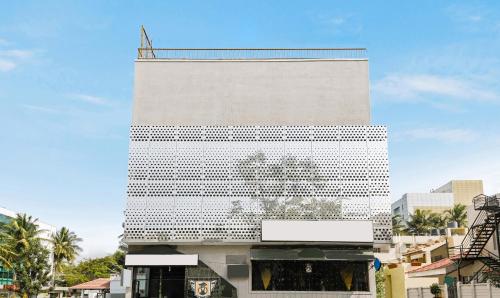 a tall white building with a lot of windows at Treebo Trend Stay Tuned JP Nagar in Bangalore