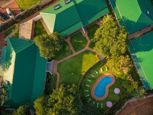 an overhead view of a park with trees and a pool at Batonka Guest Lodge in Victoria Falls