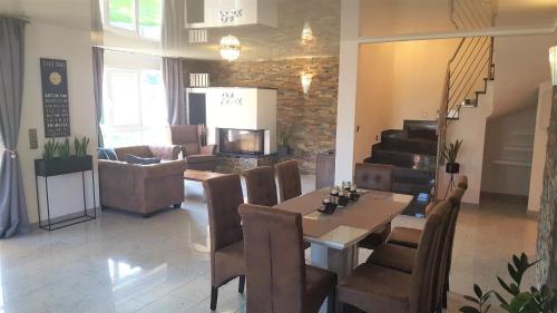 a dining room with a table and chairs and stairs at Rust-Fewo-Hotel in Rust