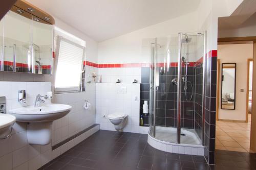 a bathroom with a shower and a sink and a toilet at Rust-Fewo-Hotel in Rust