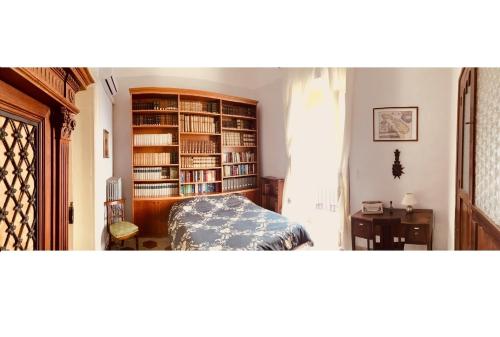 a bedroom with a book shelf filled with books at Palazzo Framarino dei Malatesta - Noble Floor - XIV Century in Giovinazzo