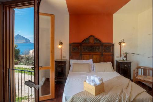 a bedroom with a bed with a box on it at Hotel Pocho in San Vito lo Capo