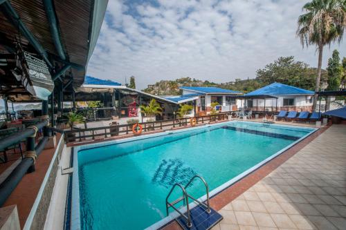 a pool at a hotel with chairs and a resort at Hotel Tilapia in Mwanza