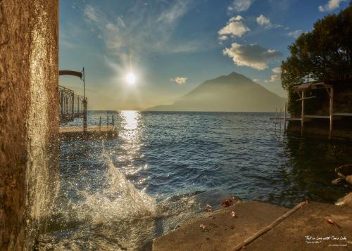 a body of water with a mountain in the background at Fall In Love with Como Lake in Bellano