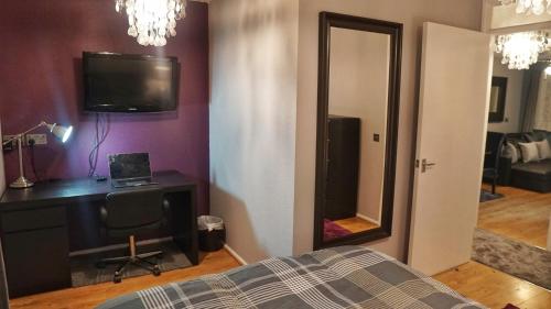a bedroom with a bed and a desk and a mirror at North London Apartment - Edmonton in Edmonton