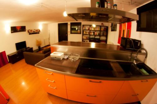 a kitchen with an orange island in a room at Alle Falesie in Duino