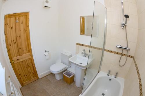 a bathroom with a toilet and a sink and a shower at 15 Saxon Road in Exeter