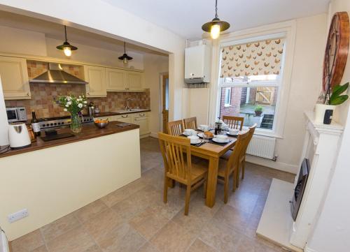 a kitchen and dining room with a table and chairs at 15 Saxon Road in Exeter
