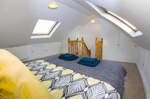 a bedroom with a bed with blue pillows on it at 15 Saxon Road in Exeter