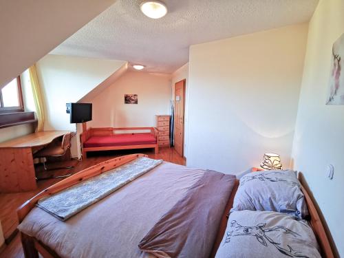 a bedroom with a large bed and a red couch at Apartment Alpine Lake in Bled