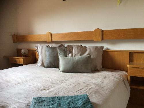 a bedroom with a large bed with white sheets and pillows at Ferienwohnung Lassendorf in Hermagor