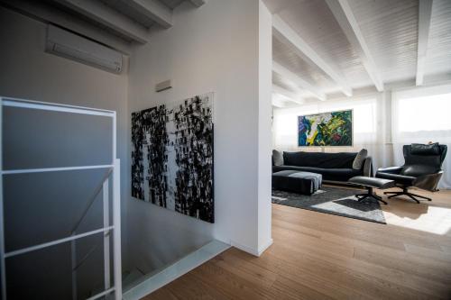 a living room with a couch and a chair at Le Cupole Suites & Apartments in Trapani