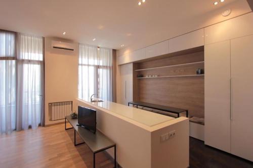 a room with a kitchen with a counter and a table at Metro apartment in Yerevan