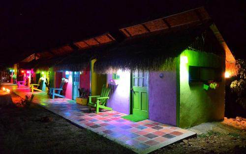 a house with colorful lights on it at night at Dunas Tatacoa in Villavieja