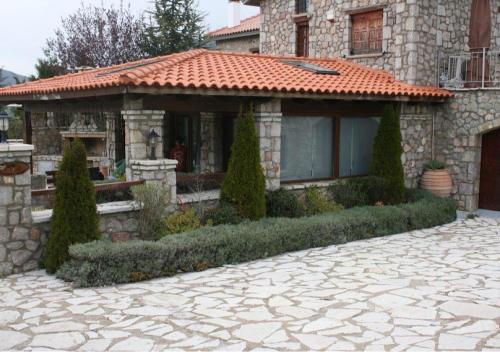 a house with a tile roof and a patio at villa in Parnassos in Arachova