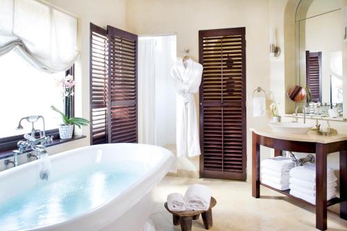 a bathroom with a bath tub and a sink and a tub at Clarendon Square in Boston