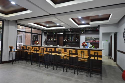 a bar with a bunch of stools in a room at Hotel Gabriella in Tagbilaran City