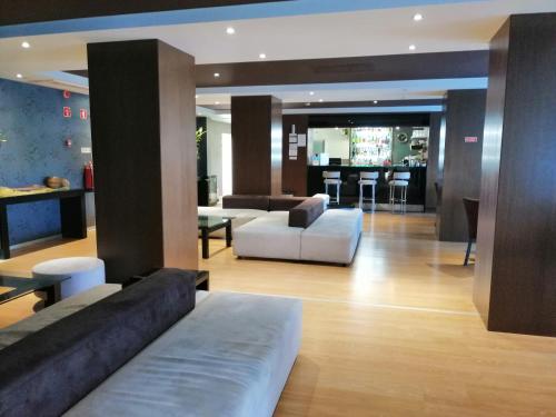 a living room with a couch and a table at Hotel Monaco in Faro