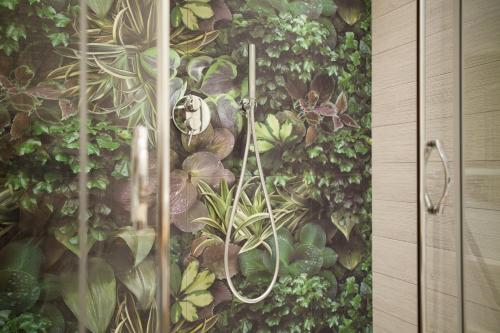 a wall with a painting of plants on it at Hotel Solemare in Milano Marittima