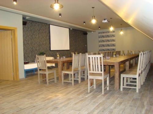 a conference room with a long wooden table and chairs at Žvejų užeiga in Šiauliai