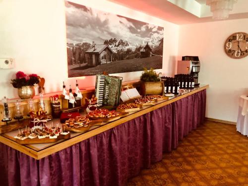 a long table with food on it in a room at Hotel De Fronz in Soraga