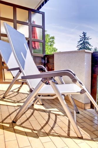 a chair sitting on top of a patio at Hotel Gartenresidence Zea Curtis in Merano