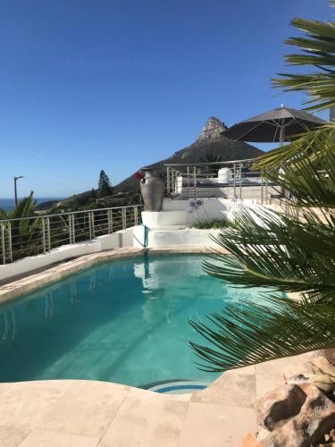 a swimming pool in the middle of a house at Four Uitsig Camps Bay in Cape Town