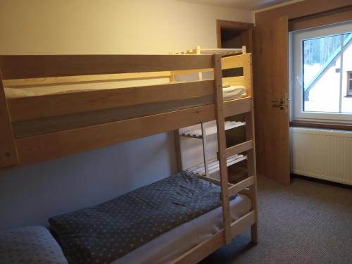 a bunk bed in a room with a bunk bed gmaxwell gmaxwell gmaxwell gmaxwell at Penzion a restaurace V Háji in Loučná pod Klínovcem