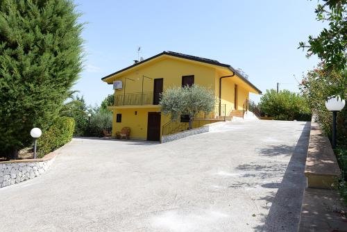 a yellow house with a driveway in front of it at Sicily Bike di Fina Rosario in Serradifalco